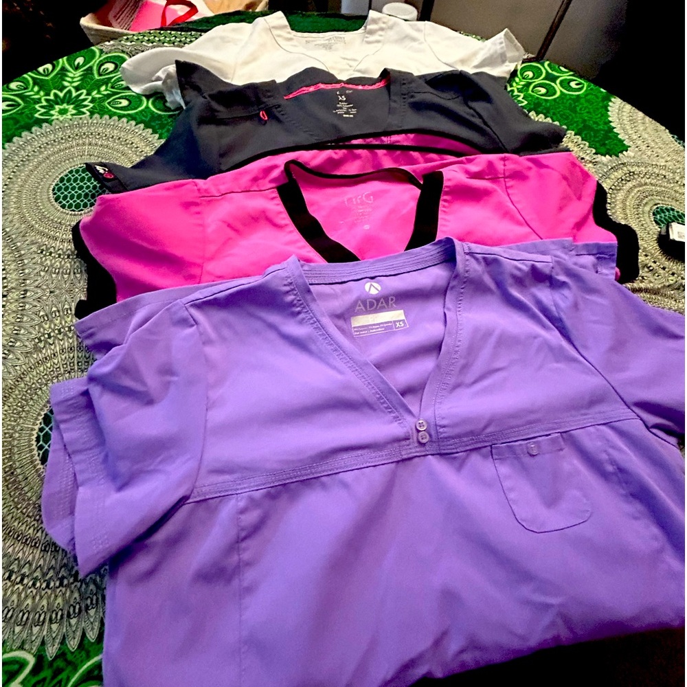 Four individual scrub tops